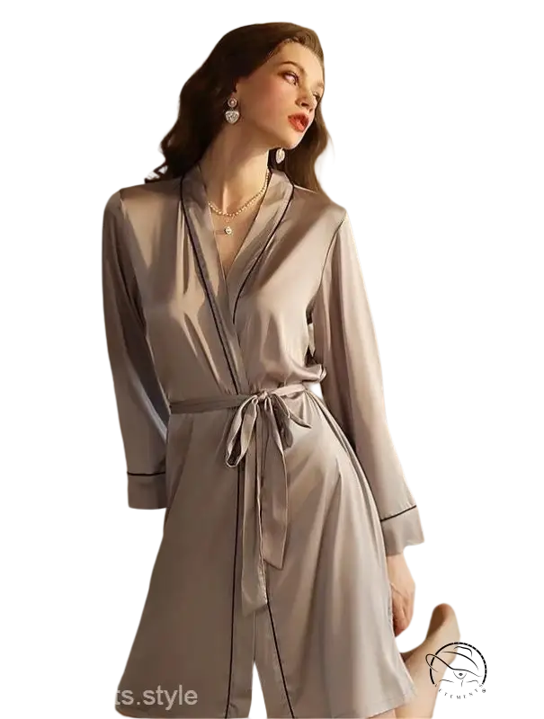 Woman in elegant gray midi silk pajamas with belted sleeves and tie waist