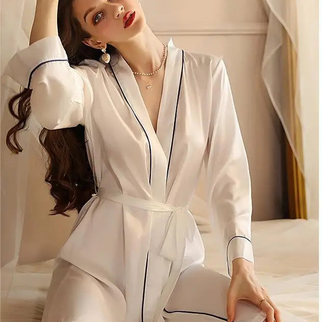 White bathrobe with navy piping worn by a woman, showcasing sexy midi silk pajamas