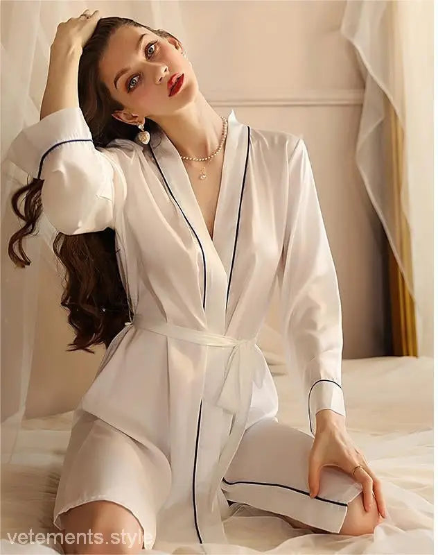 White bathrobe with navy piping worn by a woman, showcasing sexy midi silk pajamas