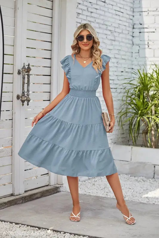 Light blue tiered midi dress with ruffled cap sleeves and elegant waist pleated design