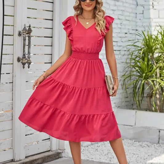Vibrant pink tiered midi dress showcasing elegant waist pleated design and ruffled cap sleeves