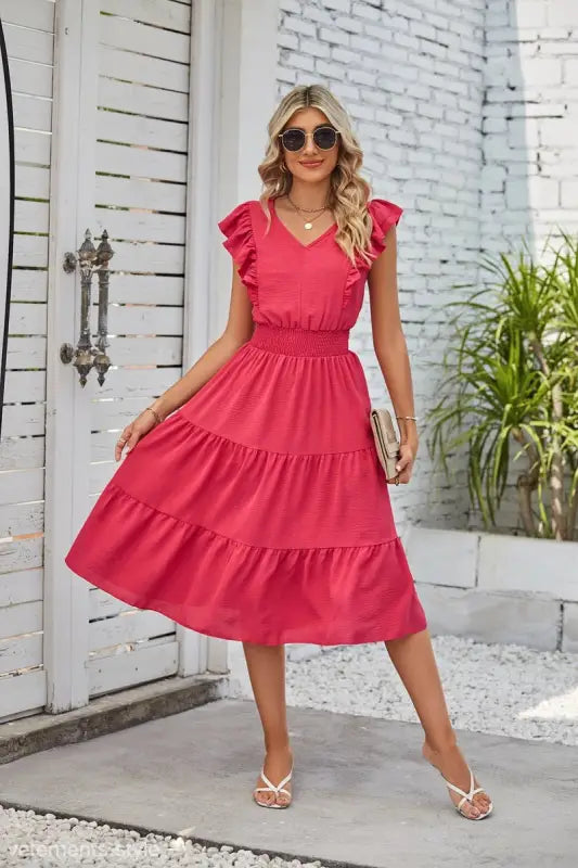 Vibrant pink tiered midi dress showcasing elegant waist pleated design and ruffled cap sleeves