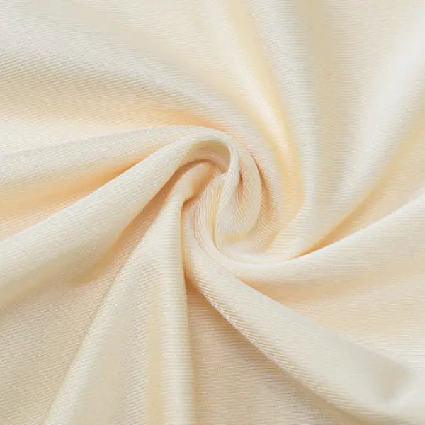 Swirled cream-colored fabric with soft folds and a silky texture.