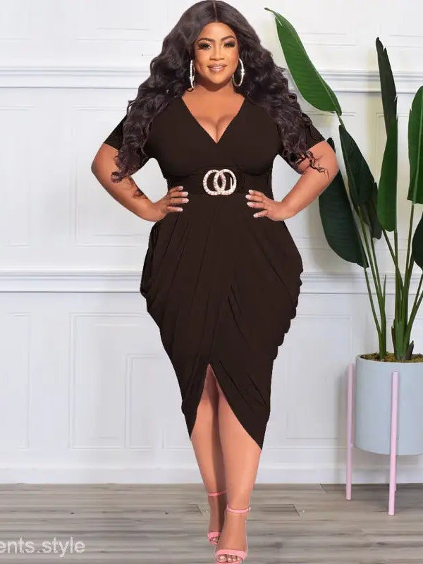 Woman in a black sexy tight split plunge dress with asymmetrical design and belt detail