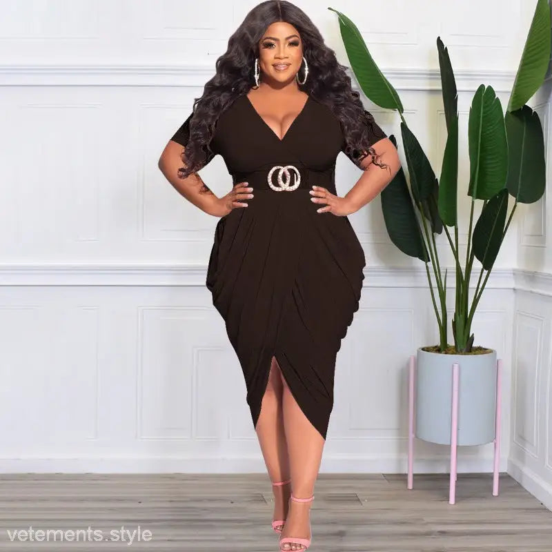 Woman in a black sexy tight split plunge dress with asymmetrical design and belt detail