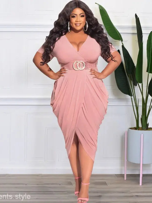 Woman in a pink sexy tight split plunge dress with belted waist and draped skirt