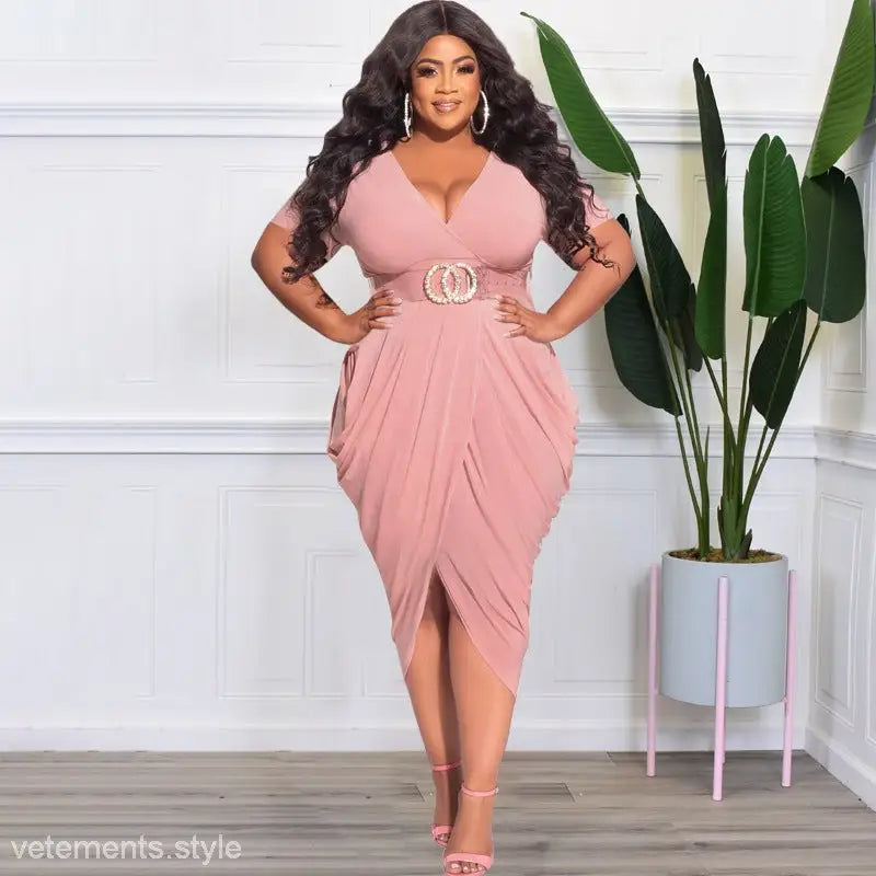 Woman in a pink sexy tight split plunge dress with belted waist and draped skirt