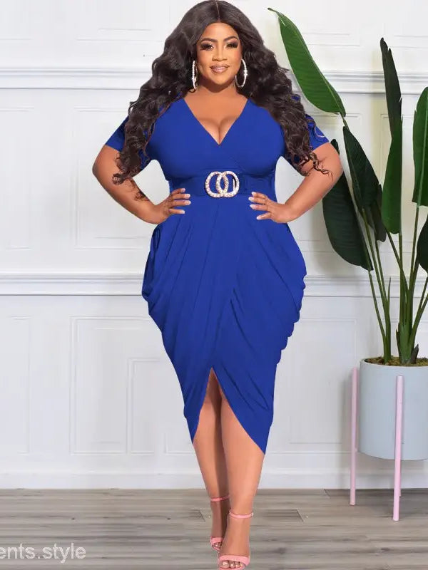 Woman wearing a vibrant blue sexy tight split plunge dress with asymmetrical design