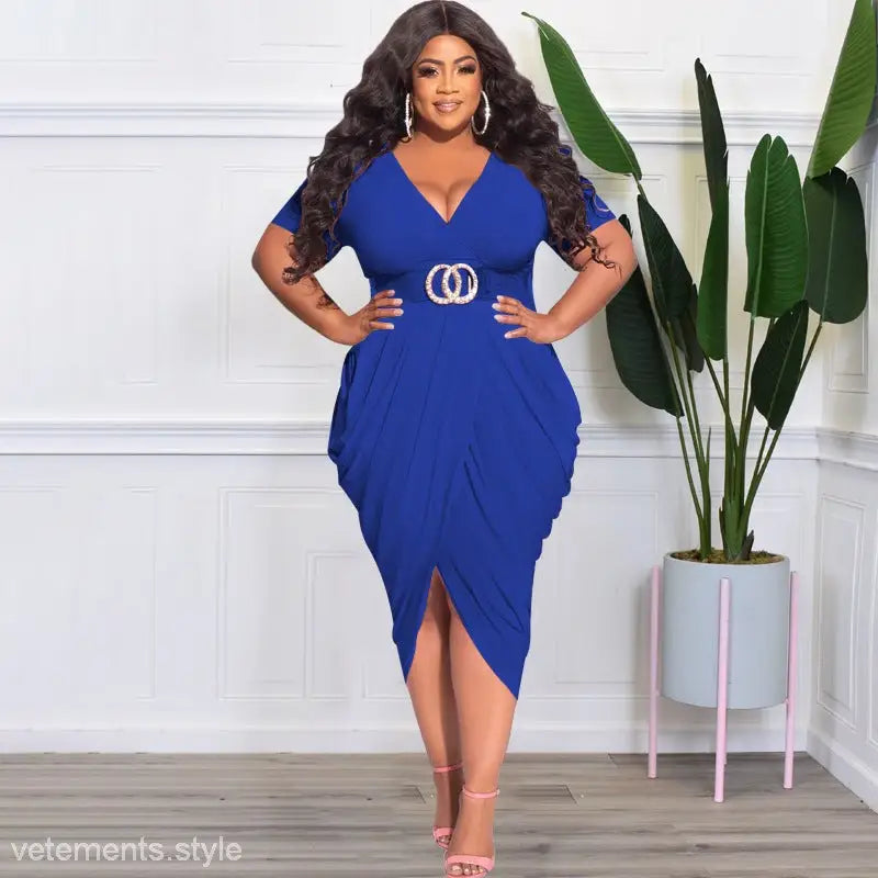 Woman wearing a vibrant blue sexy tight split plunge dress with asymmetrical design