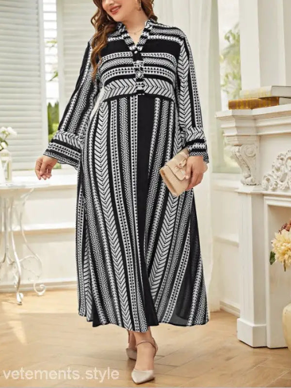 Black and white patterned maxi dress with long sleeves and artistic button waist