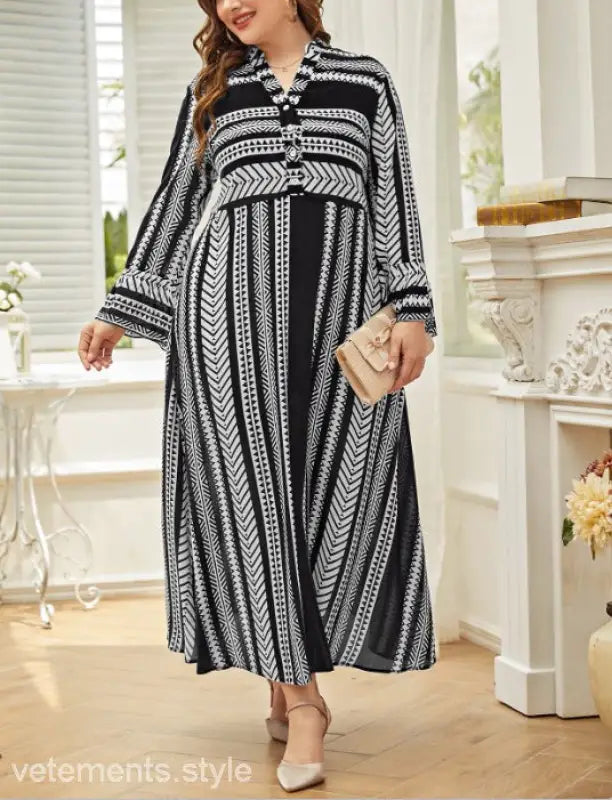 Black and white patterned maxi dress with long sleeves and artistic button waist
