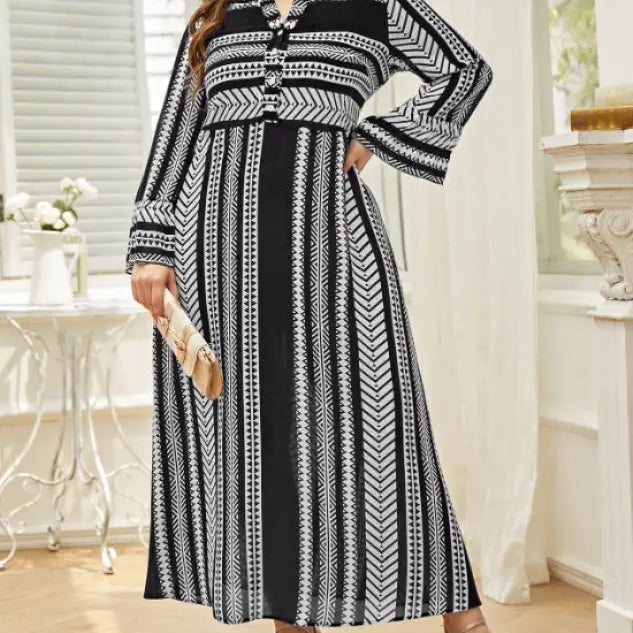 Black and white patterned maxi dress with long sleeves and artistic button waist