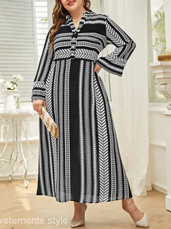 Black and white patterned maxi dress with long sleeves and artistic button waist