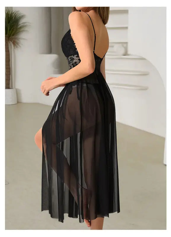 Black lace and sheer lingerie dress with spaghetti straps and a flowing skirt.