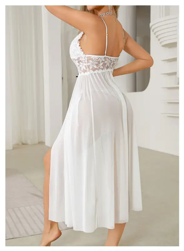 White lace-trimmed nightgown with spaghetti straps and a flowing skirt.