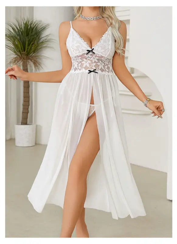 White lace-trimmed lingerie nightgown with a flowing skirt and high slit.