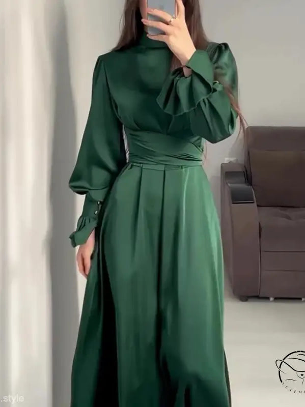 Elegant emerald green puff sleeve dress with cinched waist and high neckline
