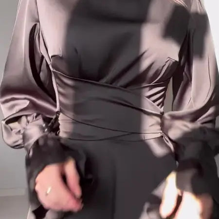 Elegant puff sleeve dress featuring a high neck, fitted waist, and billowing long sleeves