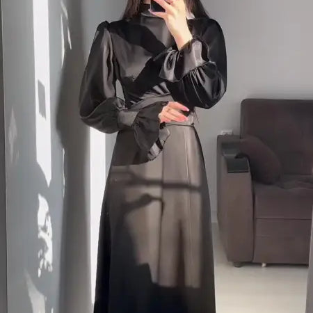 Elegant puff sleeve dress with billowy sleeves and cinched waist in a mirror selfie