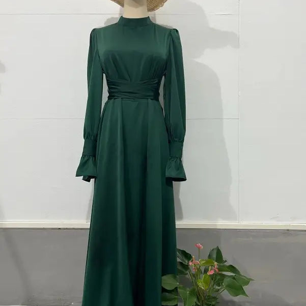 Elegant emerald green puff sleeve dress with cinched waist and flared cuffs
