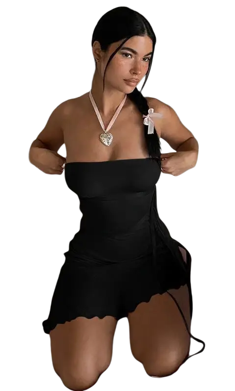 Woman kneeling on a couch in an Elegant Ribbon Ruffled Strapless Dress