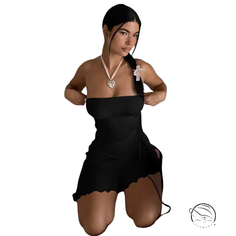 Woman in ruffled sexy strapless dress kneeling on white couch