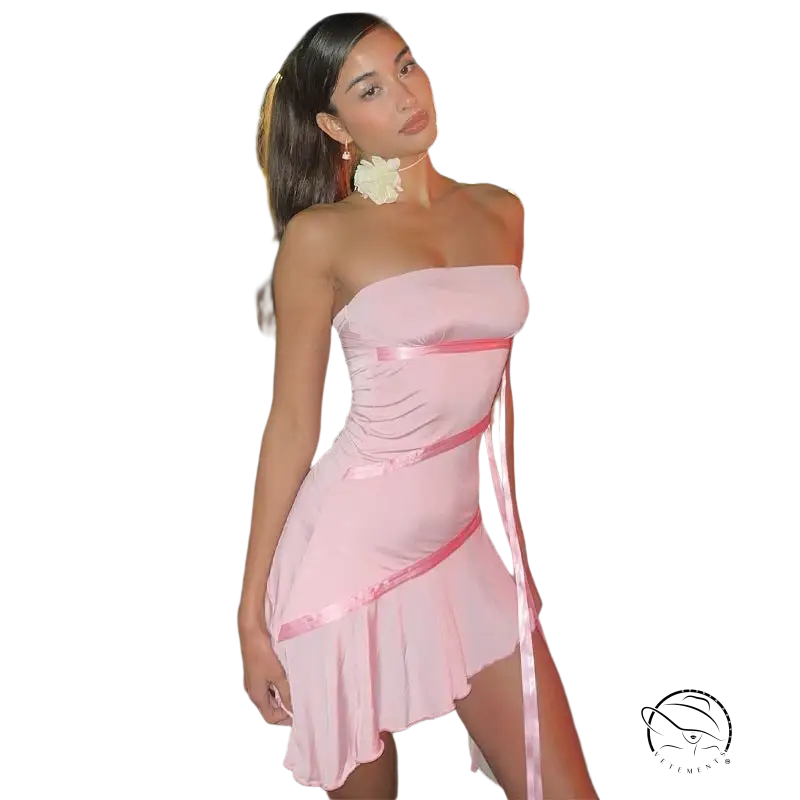 Woman in ruffled sexy strapless pink mini dress with white flower hair accessory