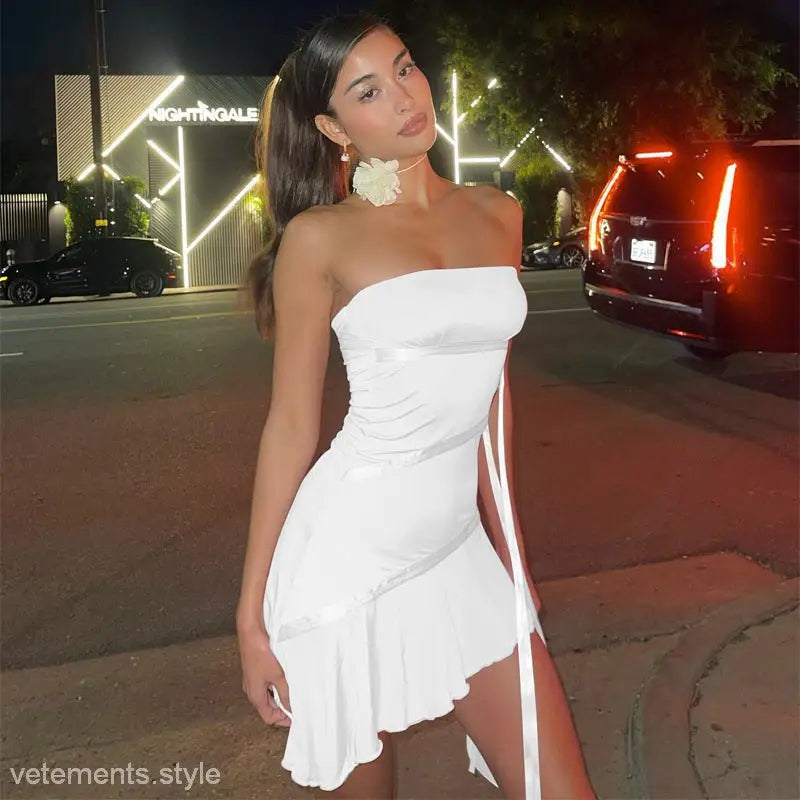 Woman in a short white sexy strapless dress with ribbon ruffled hem for elegant style