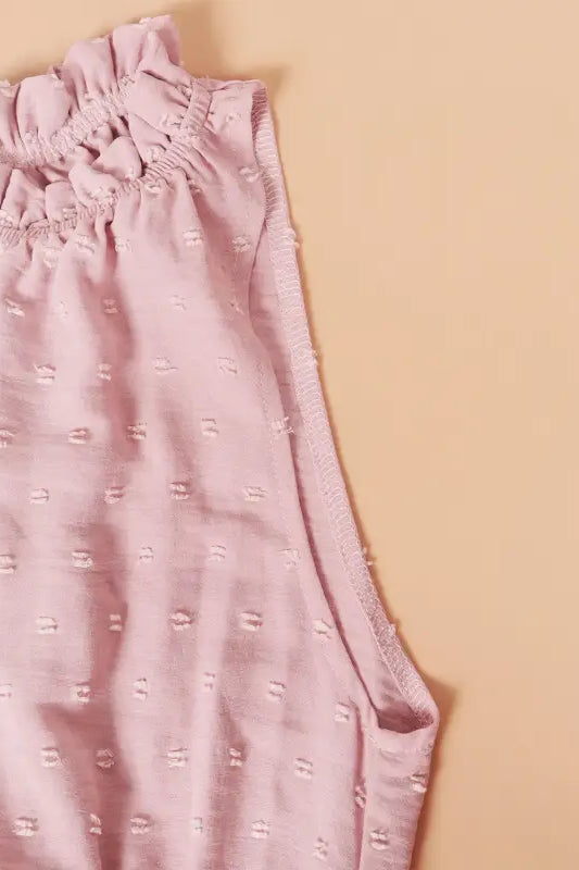 Pink sleeveless blouse with ruffled neckline, ideal as a perfect vacation dress