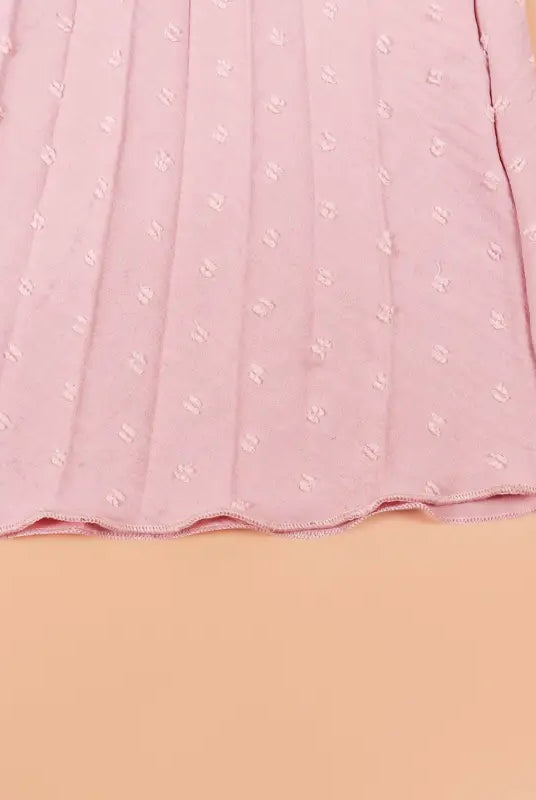 Pleated pink fabric with raised dots on elegant maxi dress, perfect vacation dress