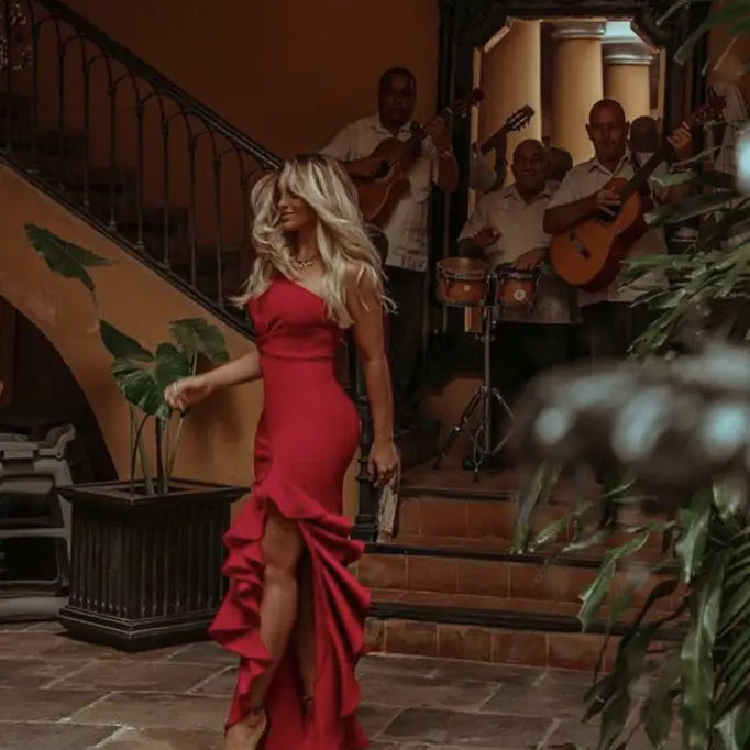 Elegant ruffled slit dress featuring a red one-shoulder design and asymmetrical ruffled details