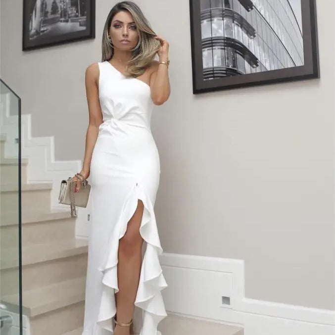 Elegant white one-shoulder gown featuring an elegant ruffled slit and asymmetric design