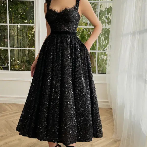 Elegant sequined midi dress with square neckline, delicate straps, and full skirt with pockets