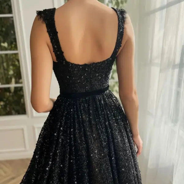Elegant sequined midi dress in lace and tulle worn by a woman from behind