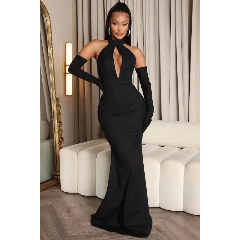 Elegant black halter gown with gloves showcasing a sexy backless cutout design