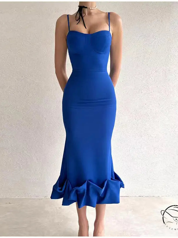 Vibrant blue form-fitting mermaid dress with spaghetti straps and a ruffled hem.