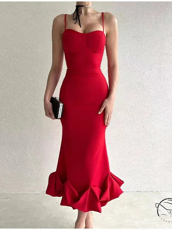 Vibrant red floor-length gown with spaghetti straps and a ruffled mermaid hem.