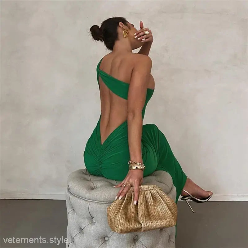 Elegant woman in a green sexy oblique shoulder backless fit hip dress for summer