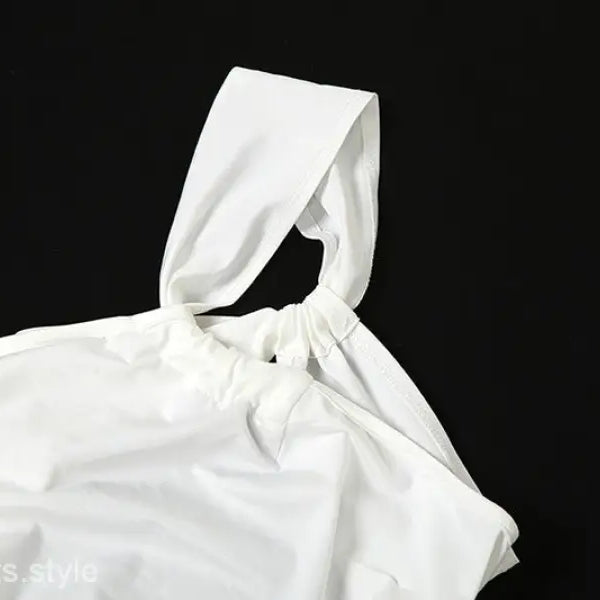 White drawstring bag complementing elegant oblique shoulder backless fit hip dress