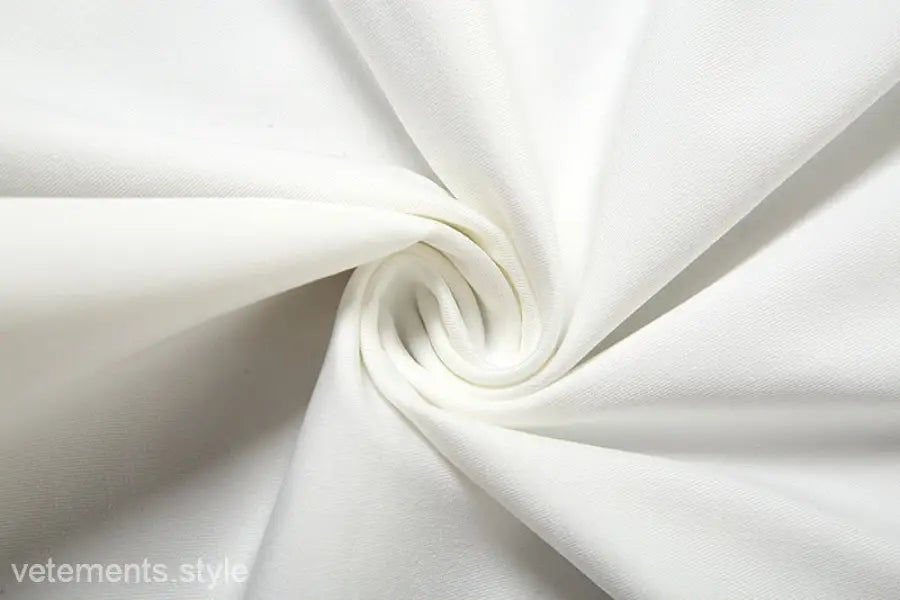 Swirling white fabric highlighting the sexy oblique shoulder design of the fit hip dress