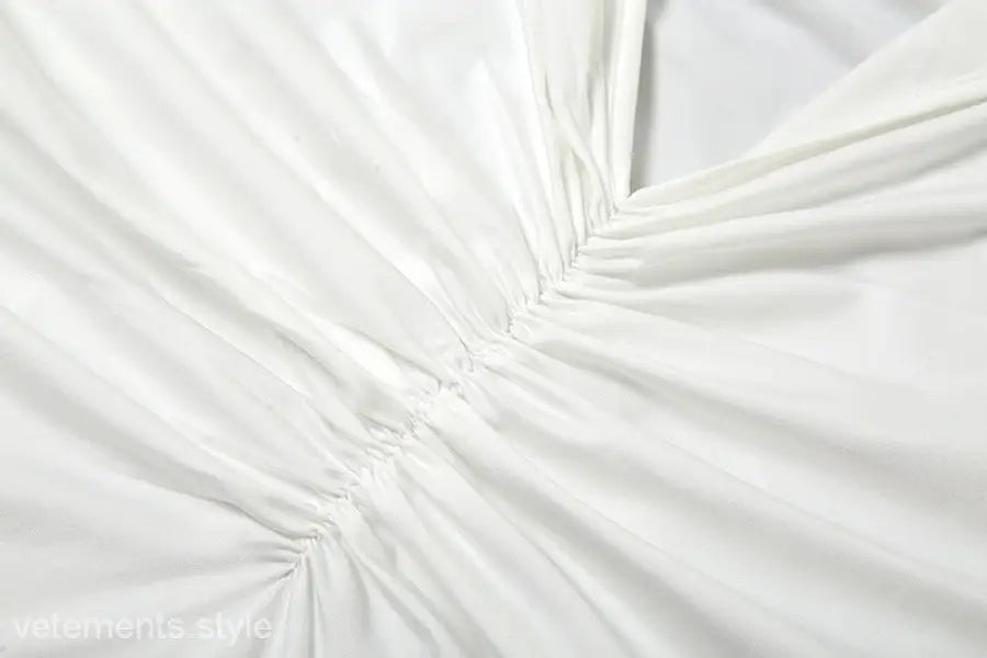 White gathered fabric of elegant oblique shoulder backless fit hip dress for summer