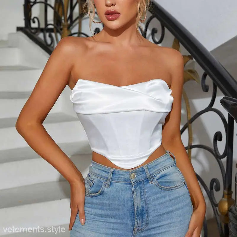 Woman in sexy pile boning corset tube top with blue jeans for summer wear