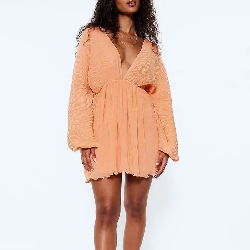 Peach-colored sexy plunge short dress with billowy long sleeves and V-neck detail
