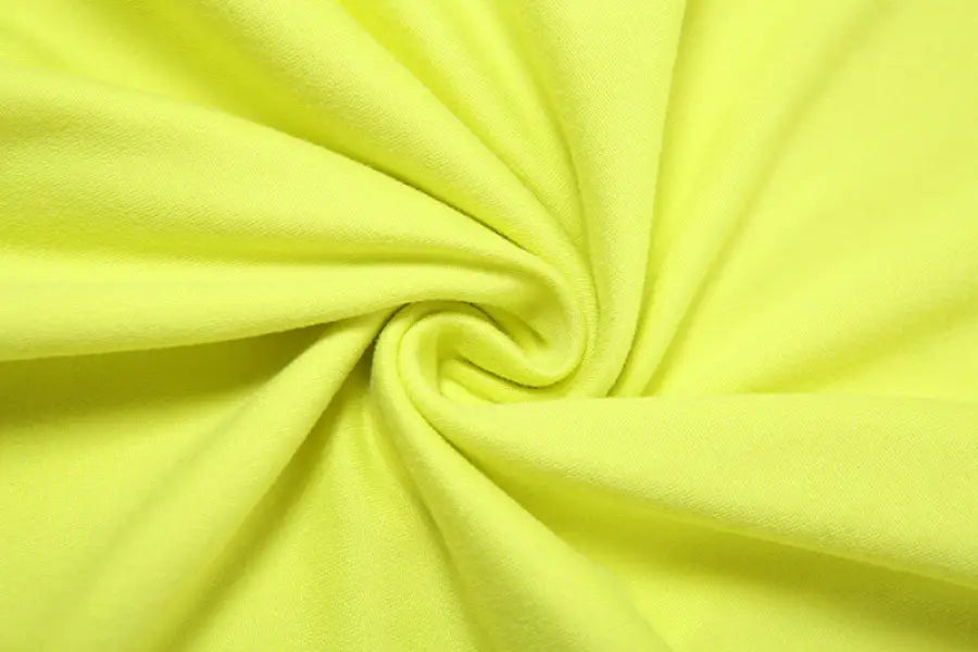 Swirled chartreuse fabric of an elegant sexy slit dress for parties and clubs