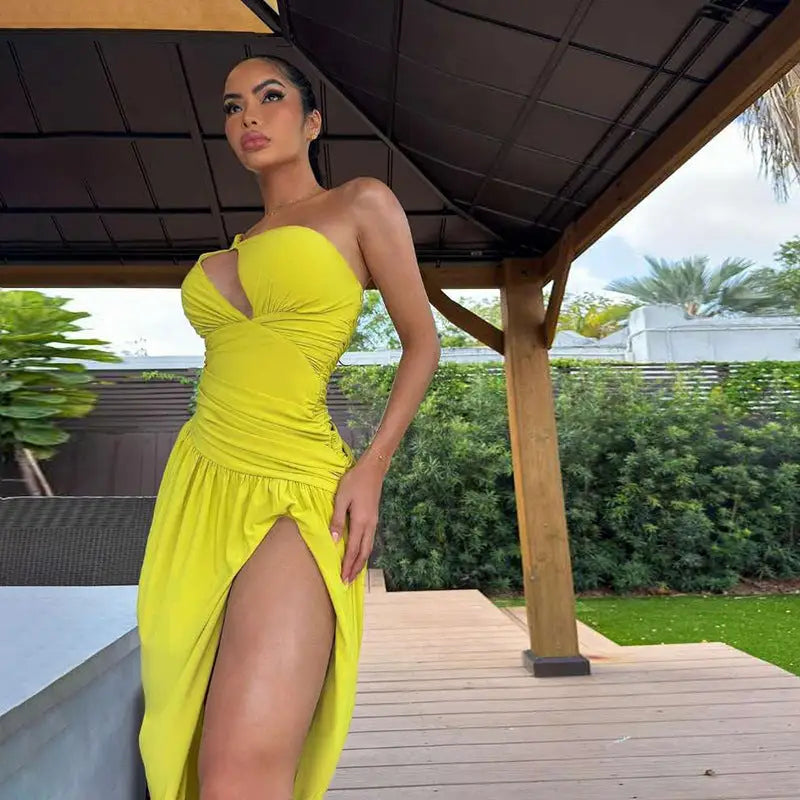 Woman in a yellow elegant sexy slit asymmetrical bodycon dress for parties and clubs