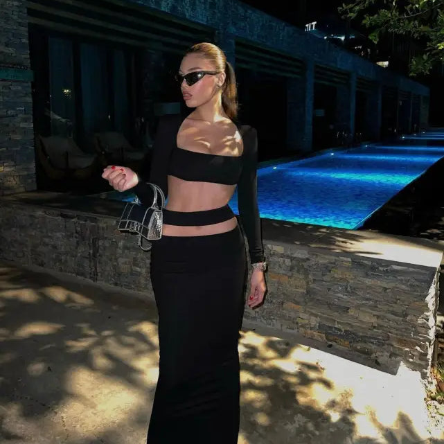 Person in a stylish black stretch bandage dress with cutout design and red heels