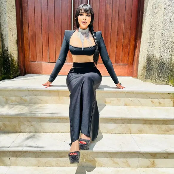 Person in a black crop top and pants showcasing a sexy stretch bandage dress design