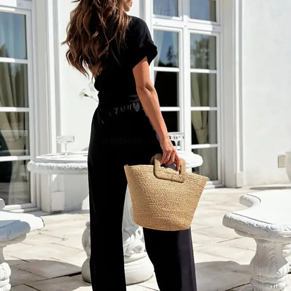 Elegant short sleeve and trousers set with woven straw tote bag for summer casual wear