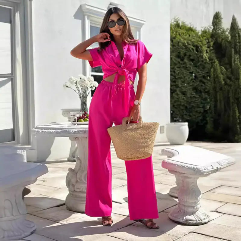 Woman in bright pink elegant short sleeve and trousers set for summer casual wear