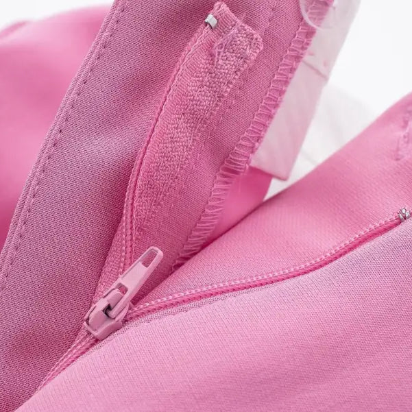 Open pink zipper on fabric of elegant casual blazer suit, short small blazer style